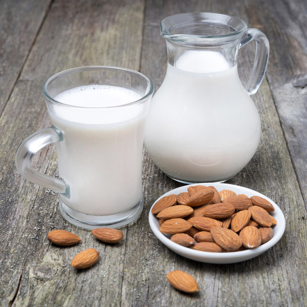 Jug and glass cup with almond milk - Foto, Bild