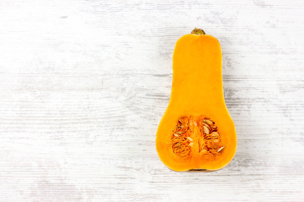 Pumpkin cuted on a white table. Sweet Pear-shaped Orange Pumpkin - Photo, Image