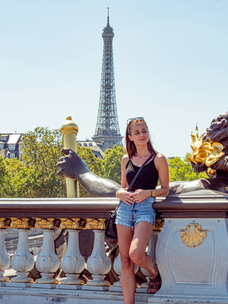 Young woman in Paris with a view over Eiffel Tower - Paris street photography - Photo, image