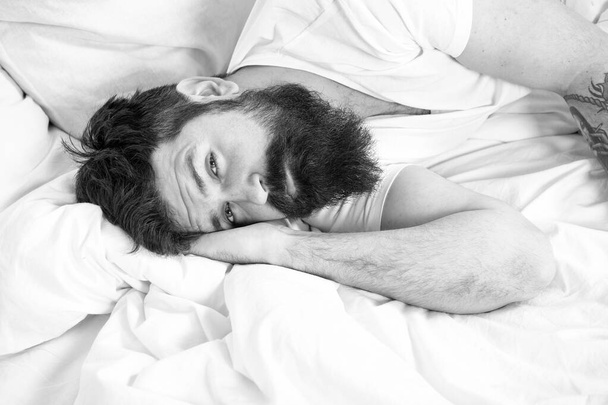 Sleep disorders concept. What a long night. Man bearded hipster having problem with sleep. Guy lying in bed try to relax and fall asleep. Relaxation techniques. Violations of sleep and wakefulness - Photo, image