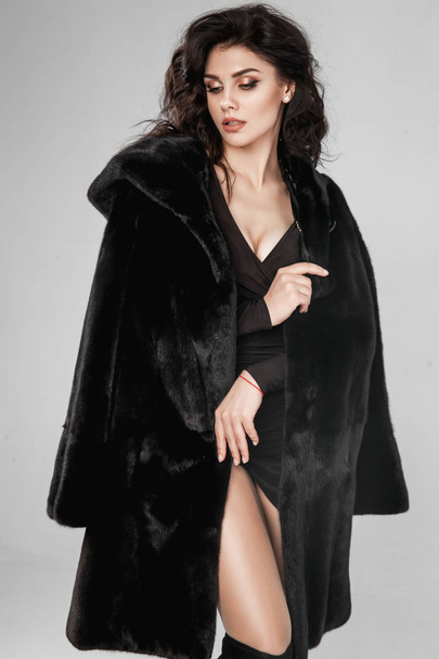 Beautiful elegant woman posing in luxury fashion fur coat over w - Foto, afbeelding