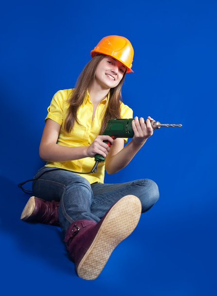 Girl with drill - Фото, изображение