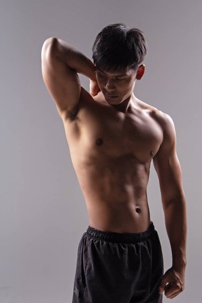 The handsome man show body muscle,from exercise,,good health,blurry light around - 写真・画像