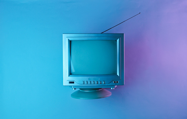 Retro wave, 80s. Old tv with antenna in holographic light. Top view, minimalism - Photo, Image