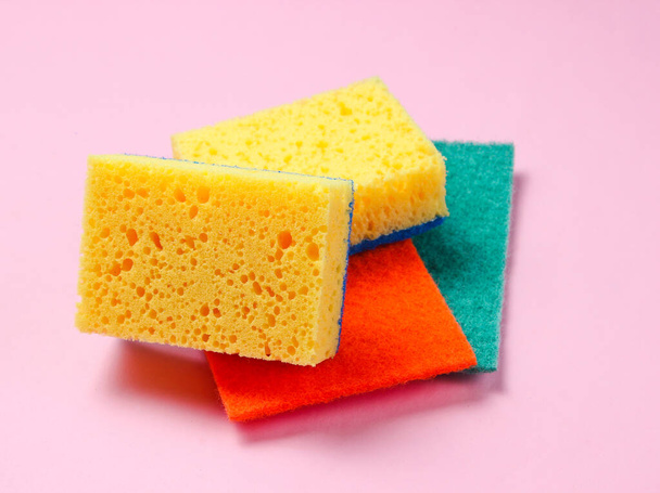 Home and bathroom cleaning kit on pink background. Sponges, abrasives. - Фото, зображення