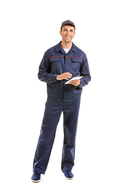 Male car mechanic with tablet computer on white background - Photo, Image