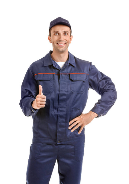 Male car mechanic showing thumb-up on white background - Foto, imagen
