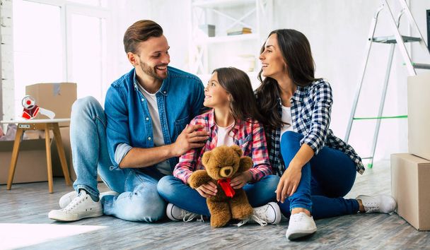 Happy young family in their new apartment - Fotoğraf, Görsel
