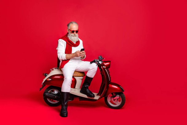 Full length body size view of his he nice attractive stylish trendy confident focused gray-haired man internet online browsing free time 5g isolated over bright vivid shine red background - Valokuva, kuva