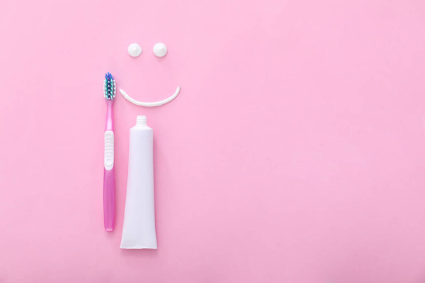 Tooth brush, paste and drawn smile on color background - Фото, изображение