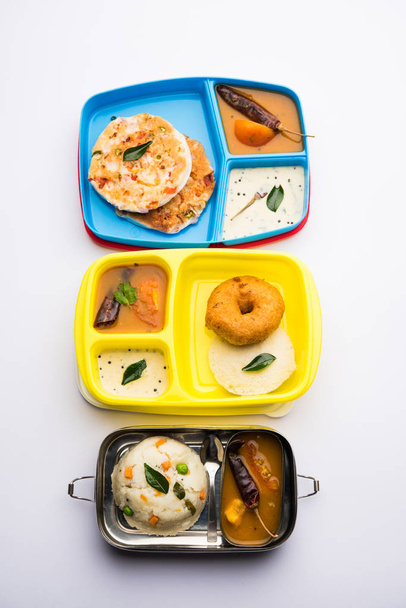 Assorted South Indian tiffin / lunch box food in group, includes idli vada, uttapam/uthappam, upma with sambar and chutney - Photo, Image