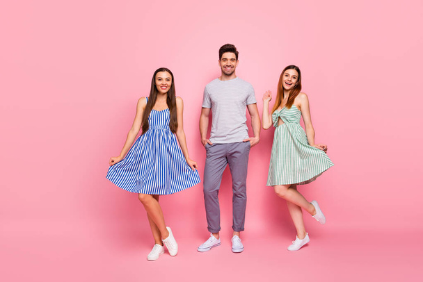 Full body photo of cheerful guys posing smiling wearing striped t-shirt dress skirt isolated over pink background - Foto, afbeelding