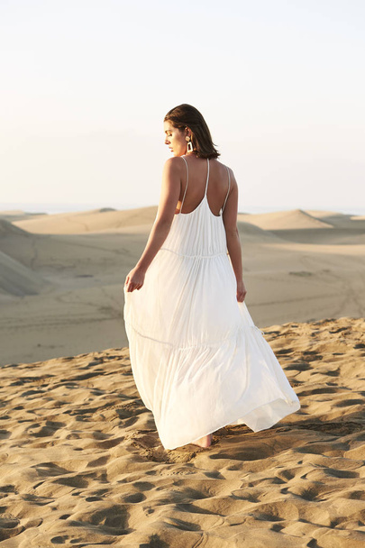 beautiful woman in white dress standing in desert - Foto, Imagen