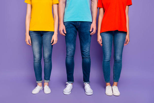 Close up photo of three people standing straight wearing street style clothes isolated violet background - Foto, imagen