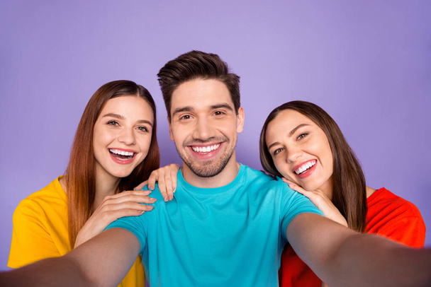 Close up photo portrait of one handsome charismatic with bristle hipster and two beautiful nice cheerful kind ladies leaning on his shoulders isolated over violet background - Fotó, kép
