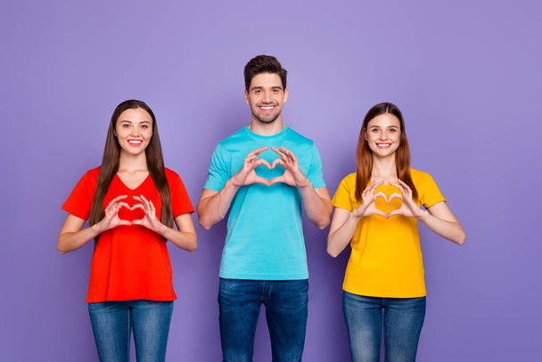 Photo of three beautiful handsome nice glad positive ladies and one guy expressing gesturing their viewpoint to you isolated violet background - Foto, immagini