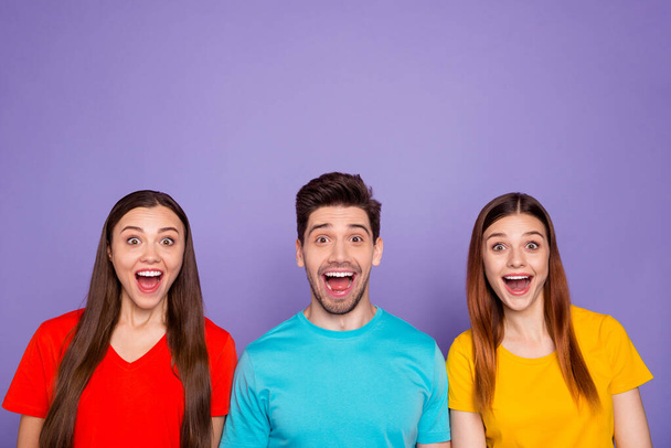 Portrait of nice attractive lovely charming cute cheerful cheery glad guys wearing colorful t-shirts good news amazement expression isolated over violet lilac background - Foto, Bild
