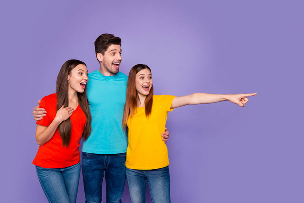 Portrait of nice attractive lovely cheerful cheery glad guys wearing colorful t-shirts denim pointing far away waiting expecting isolated over violet lilac background - Foto, Bild
