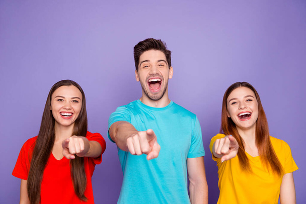 Portrait of nice-looking attractive lovely charming cheerful cheery funny guys wearing colorful t-shirts pointing at you laughing having fun isolated over violet lilac background - Photo, Image