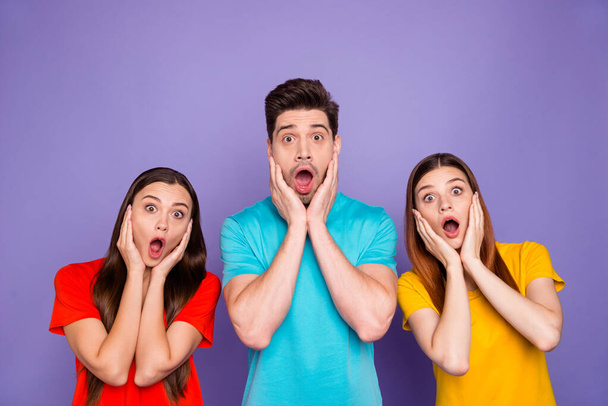 Portrait of nice-looking attractive lovely afraid guys wearing colorful t-shirts showing astonishment facial emotion expression stupor isolated over violet lilac background - Фото, изображение