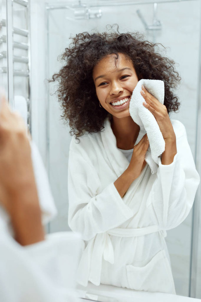 Woman cleaning face skin with white towel at bathroom portrait - Φωτογραφία, εικόνα
