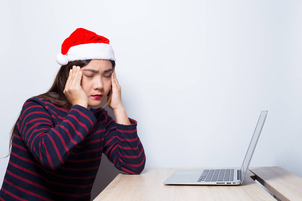 Mujer tiene dolor de cabeza del trabajo en el día de Navidad
 - Foto, imagen