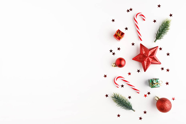 Χριστουγεννιάτικη σύνθεση. Χριστουγεννιάτικα ζαχαρωτά, δώρα, μπάλες και κλαδιά ελάτης. Επίπεδο lay, πάνω όψη - Φωτογραφία, εικόνα