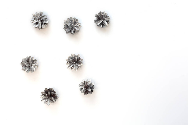 Christmas composition. Silver pine cones on white background. - Foto, Imagem
