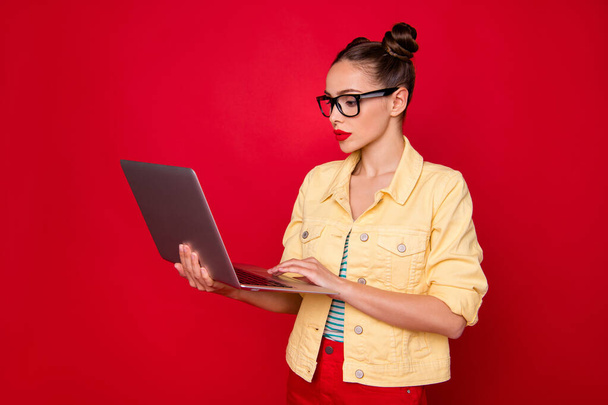 Photo of pretty lady holding notebook hands wear specs casual stylish outfit isolated red background - Fotoğraf, Görsel