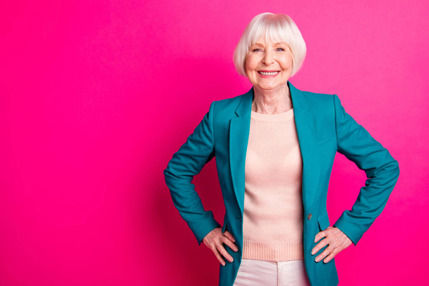 Portrait of her she nice-looking attractive lovely cheerful cheery content gray-haired lady wearing blue green jacket posing isolated over bright vivid shine vibrant pink fuchsia color background - 写真・画像