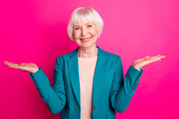 Portrait of her she nice attractive lovely cheerful cheery gray-haired lady holding invisible objects on palms new novelty isolated over bright vivid shine vibrant pink fuchsia color background - Фото, зображення