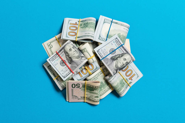 Many Stack of 100 dollar bills. Isolated on colored background top wiev with copy space - 写真・画像