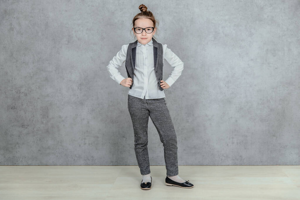 Full-length portrait of little business lady giving the case and attention gesturing, isolated on a gray background. Concept of leadership and success. - Photo, image