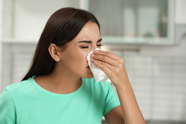 Young woman suffering from allergy in kitchen - Photo, image