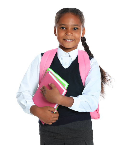 Happy African-American girl in school uniform on white background - Foto, afbeelding