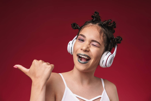 Image of happy punk girl with bizarre hairstyle pointing finger  - Φωτογραφία, εικόνα