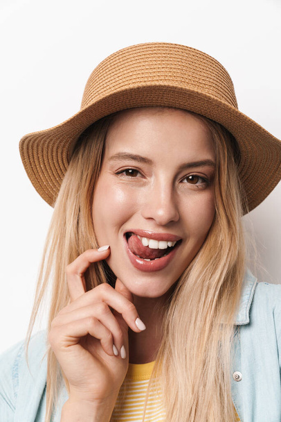 Flirty amazing young pretty woman wearing hat posing isolated over white wall background showing tongue. - Φωτογραφία, εικόνα