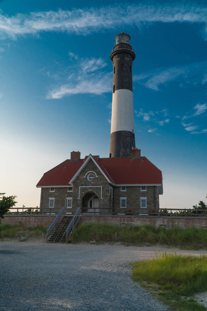 Beautiful dramatic color vertical frame shot of generic light house during evening time - Photo, Image