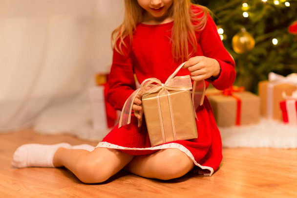 close up of girl with christmas gift at home - Фото, изображение