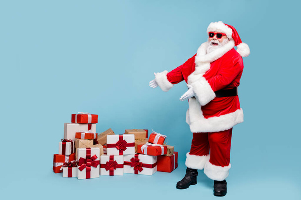 Full length body size view of his he nice fat cheerful cheery glad bearded Santa showing demonstrating pile stack seasonal purchases isolated over blue turquoise pastel color background - Photo, Image