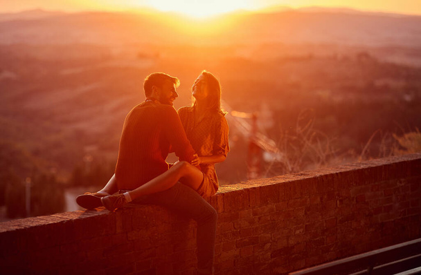 Lovers. romantic at sunset. Couple smiling and enjoying together - Fotó, kép