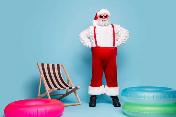 Full length body size view of his he nice stylish confident cheerful fat overweight Santa traveler at poolside party hands on hips isolated over blue turquoise pastel color background - Φωτογραφία, εικόνα