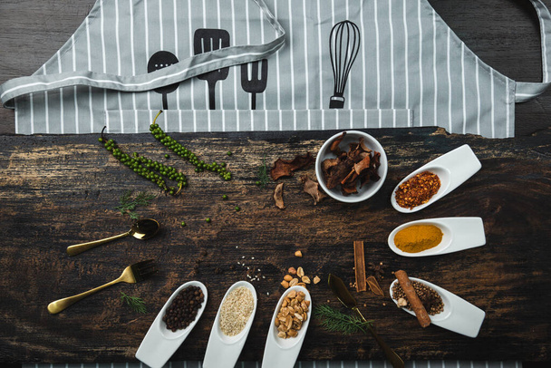 Various colorful herbs and spices on wooden table. Top view of spices and herbs. Spices and herbs over on wooden table background. - Photo, Image