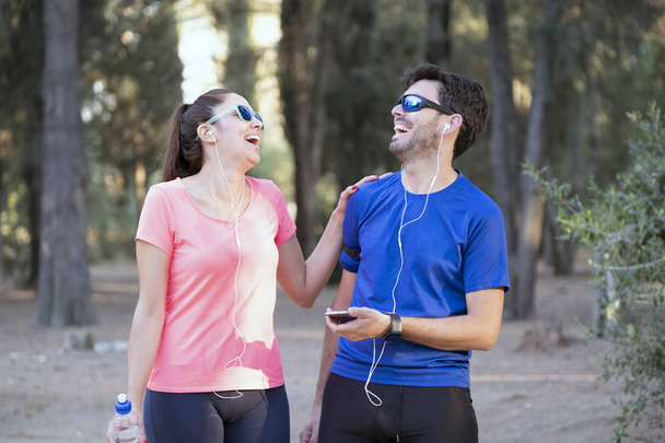 Image of excited man and woman with headphones listening to musi - Photo, Image