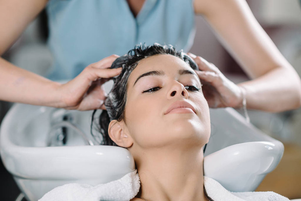 stylist Washing hair of client  in hair salon  - Фото, зображення