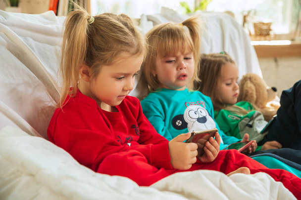 Little girls in soft warm pajamas playing at home - Foto, Bild