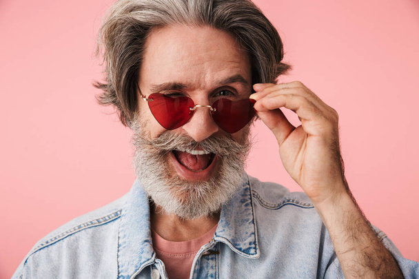Portrait of stylish old man with gray beard wearing fashion sung - Foto, Imagem