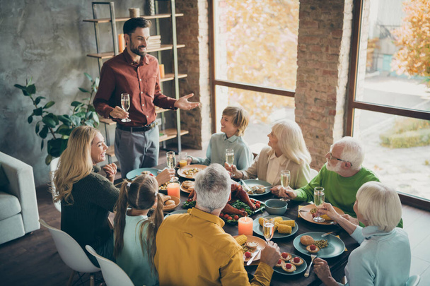 Portrait of nice cheery big full family brother sister granddaughter grandson enjoying generation gathering domestic festive dad saying toast grateful in modern loft industrial style interior house - 写真・画像