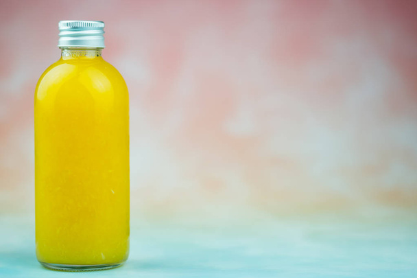 Bottle of orange juice made of fresh oranges  - Photo, Image