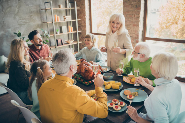 Portrait of nice cheerful big full family brother sister eating domestic brunch lunch feast generation gathering tradiotion grandma saying toast in modern loft industrial style interior house - Fotó, kép
